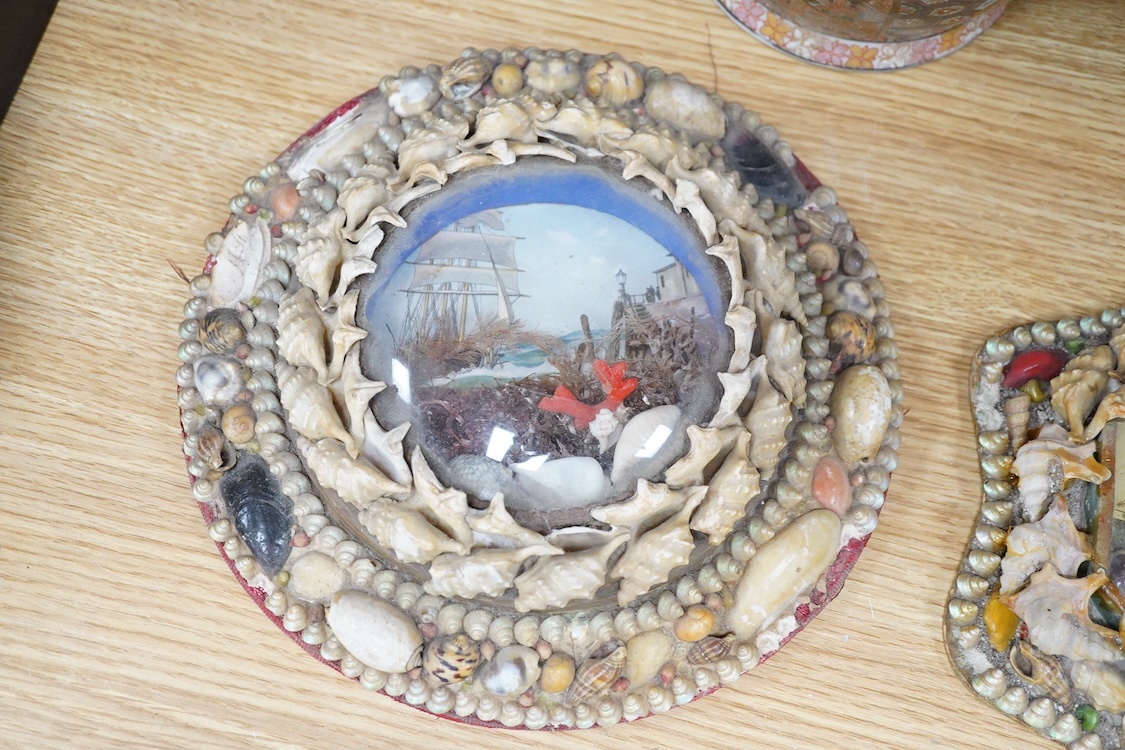 A collection of seven shellwork frames with convex glass, housing maritime interest prints with seaweed and shell decoration, largest 23cm in diameter